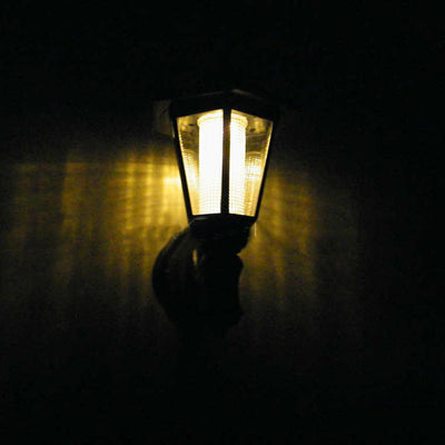 Durable solar-powered hexagonal wall lamp for garden lighting, offering warm, ambient illumination