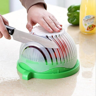 Person using a green vegetable slicer to cut vegetables on a white surface.